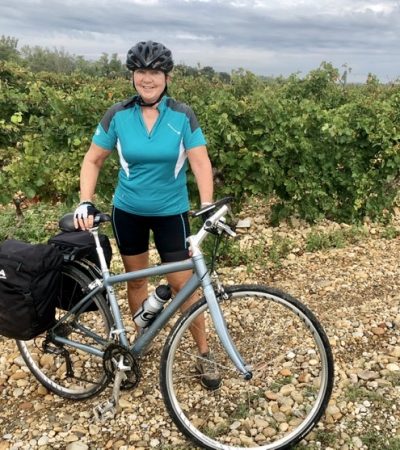 Cate in front of the vines